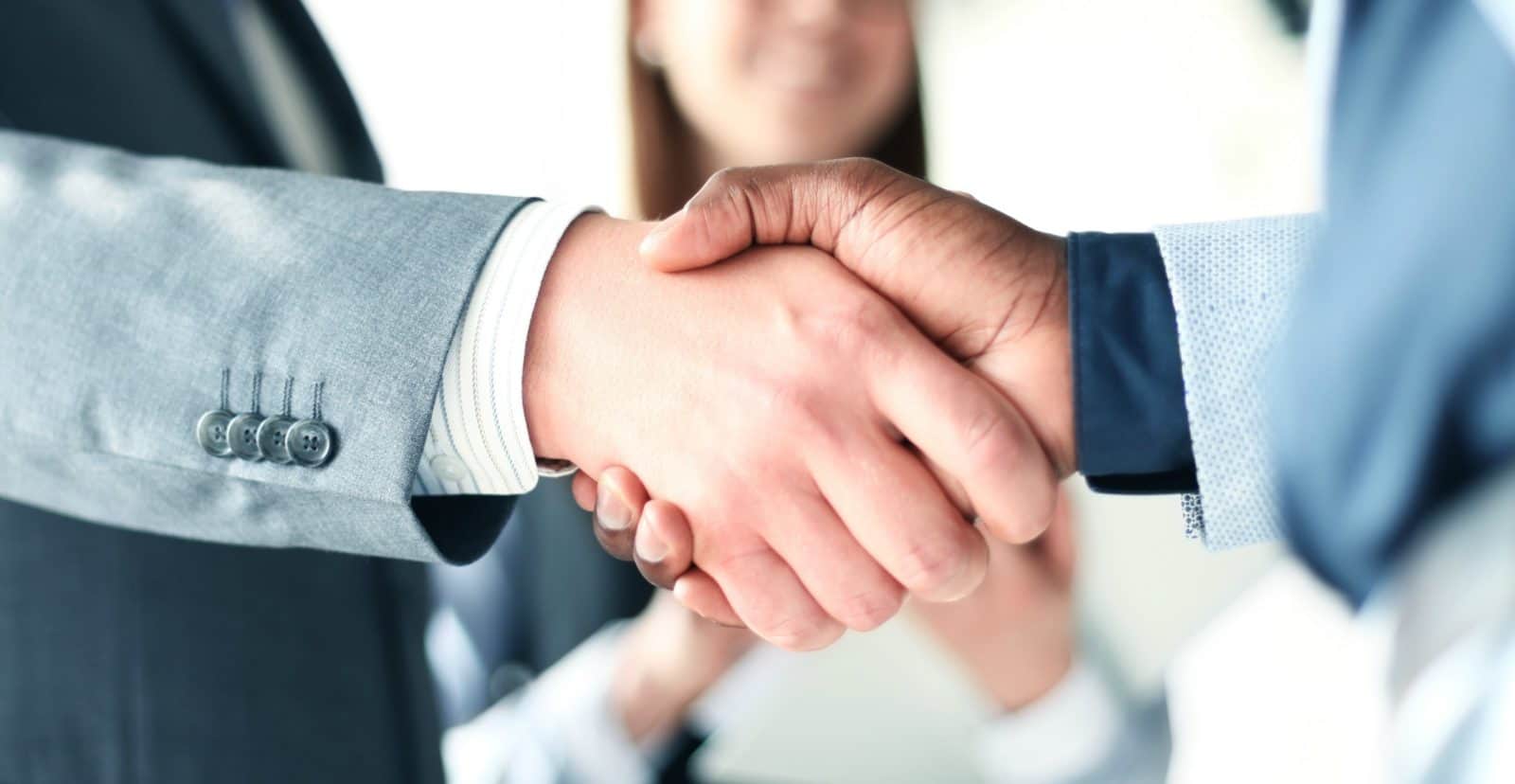 Two businessmen shaking hands after agreeing to telecom managed services